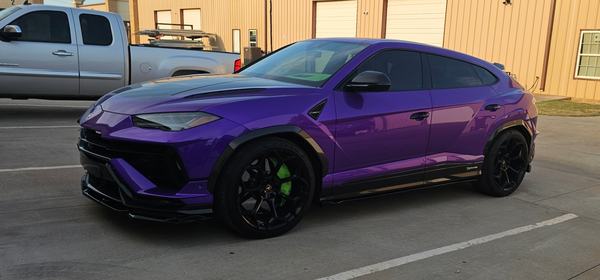 Purple SUV outside the shop showing carbon fiber side skirts and a front splitter