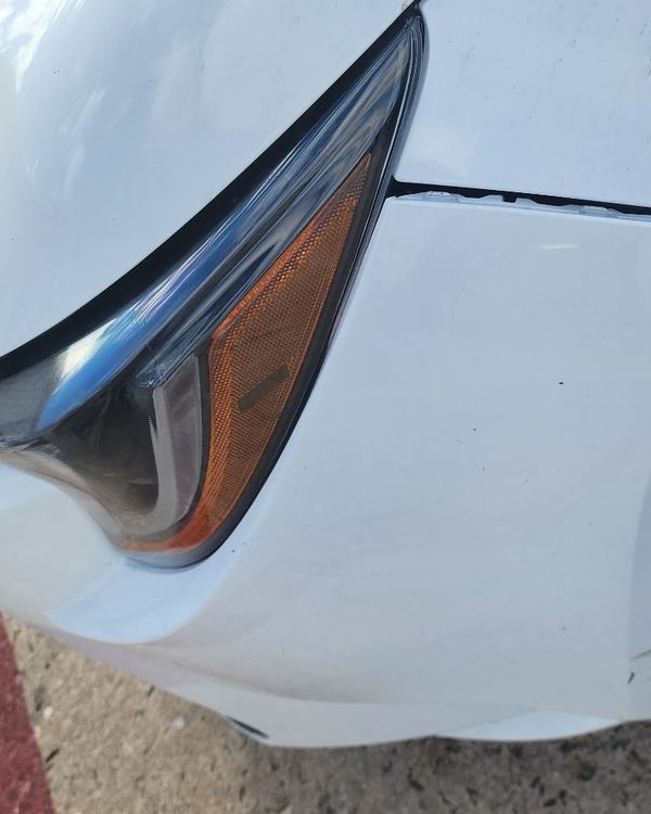Before: white sedan front bumper and fender